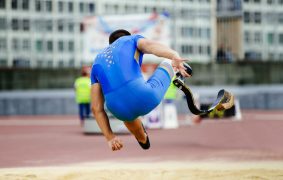 male paraathlete long jump in competition