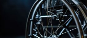 Detail of a wheelchair wheel with a dark background